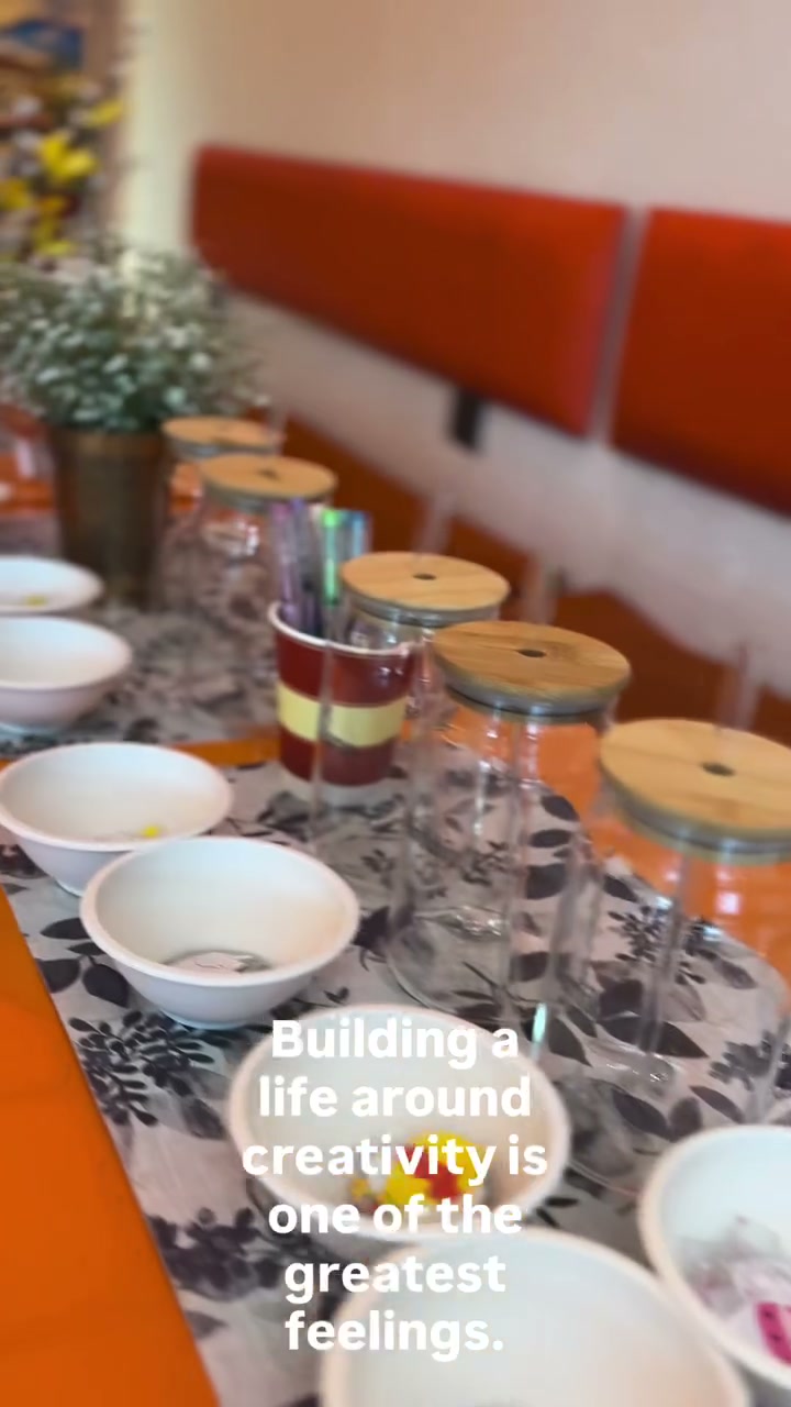 Craft table set up with glass tumblers and paint bowls at the kids workshop